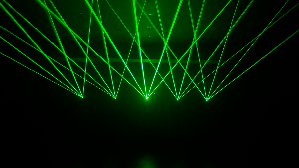 Green laser lights being projceted by a 3D laser projected called Lasercube