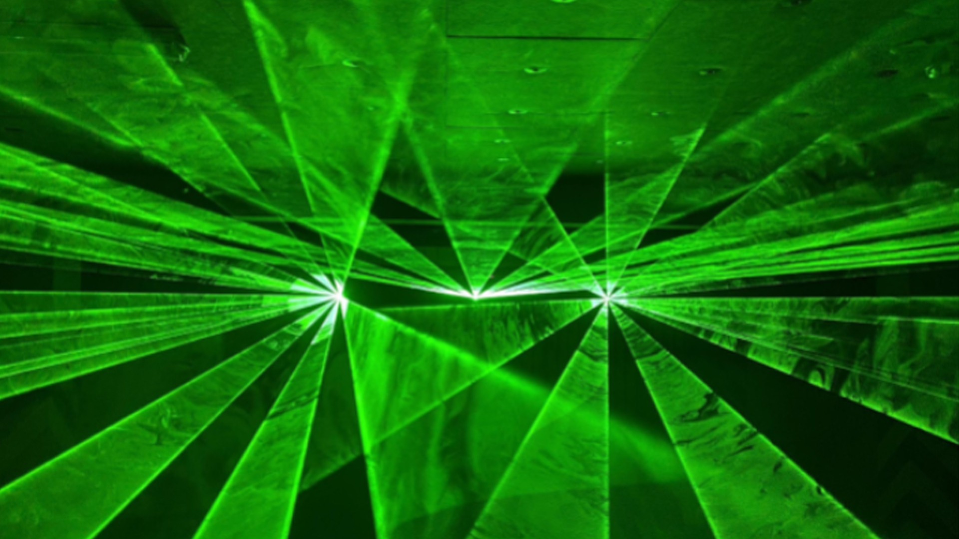 Green laser lights being projceted by a 3D laser projected called Lasercube