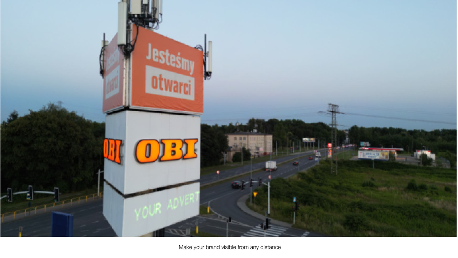 A large signage outdoor with the text "your advert" projected onto it from a Lasercube laser projector, showcasing how it can be used for outdoor advertising