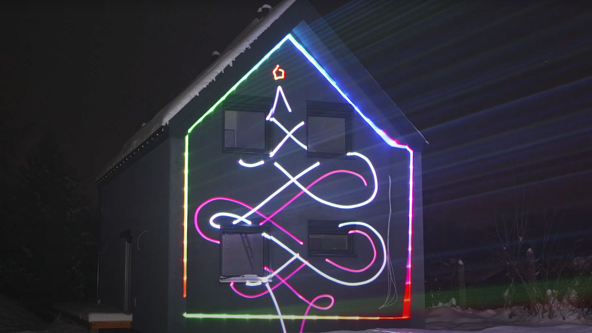 House lit up by a Christmas Light Laser Projector showing Christmas laser show effects