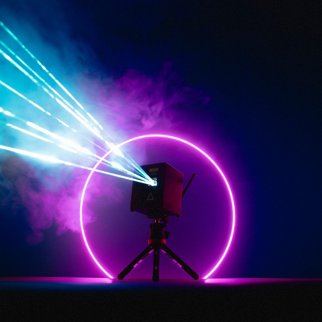 wifi-new-4 Lasercube with purple strobe light circle projecting lasers in a dark environment.